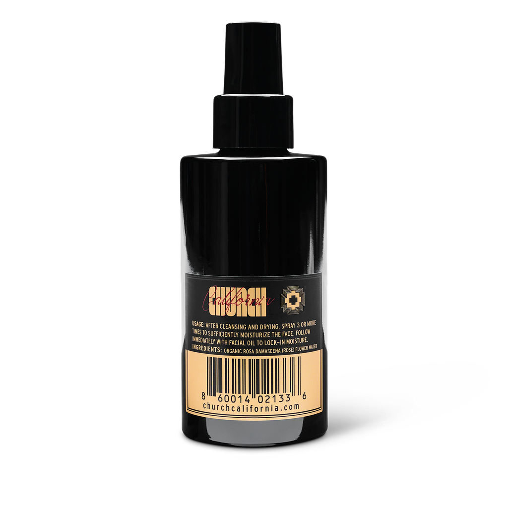 Black spray bottle with label on a white background