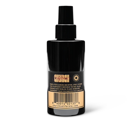 Black spray bottle with label on a white background