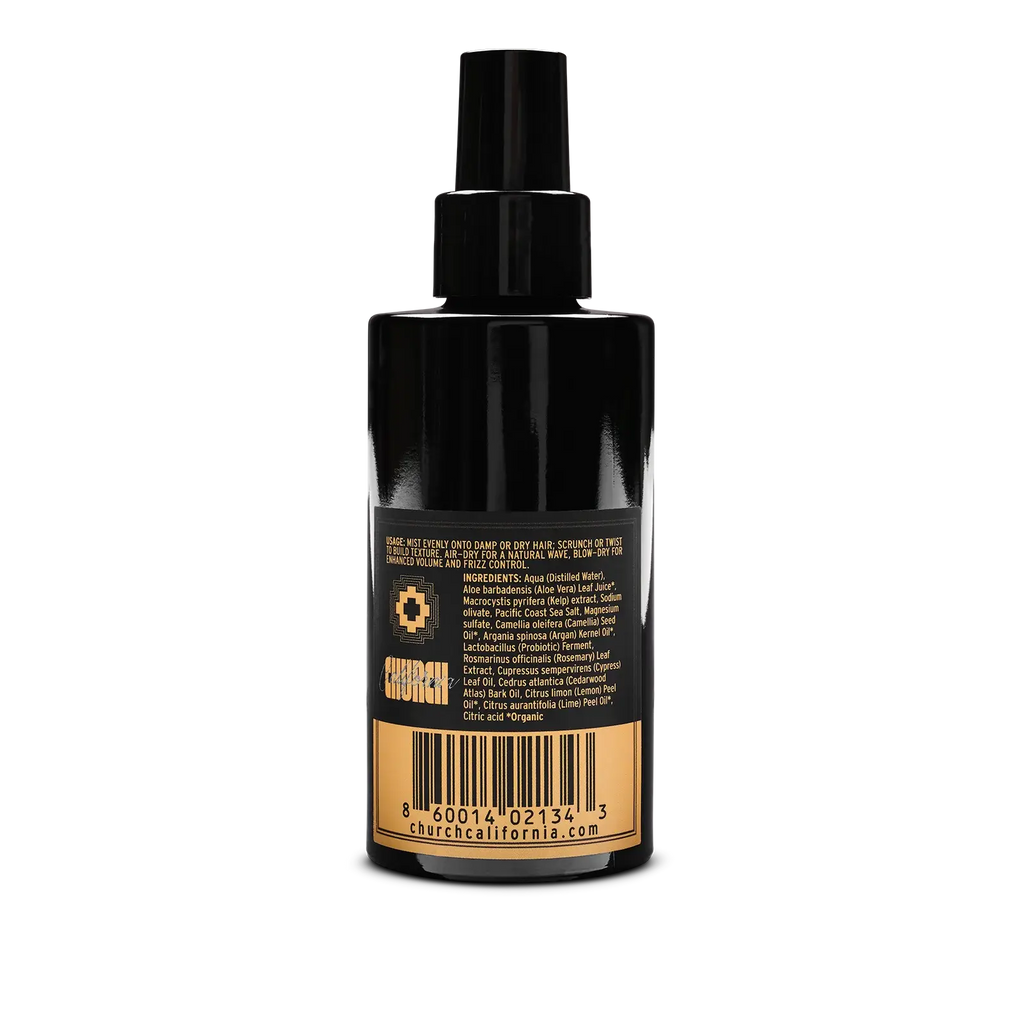 A black spray bottle with a black pump dispenser, showing the back label which features a gold barcode and the brand name 'CHURCH' in gold text, set against a plain white background.
