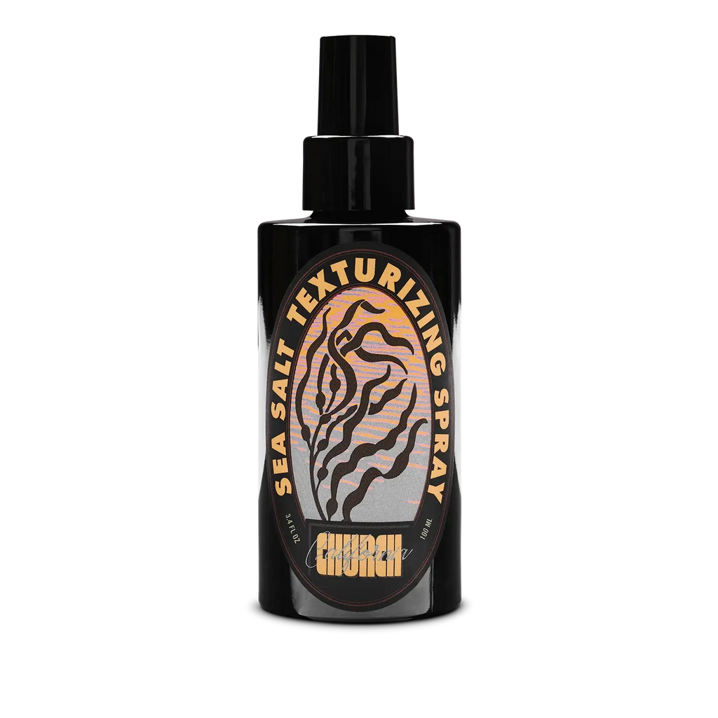 A black spray bottle of Church California Sea Salt Texturizing Spray with a black nozzle, featuring a circular label with a tiger-stripe design and gold lettering on a white background.