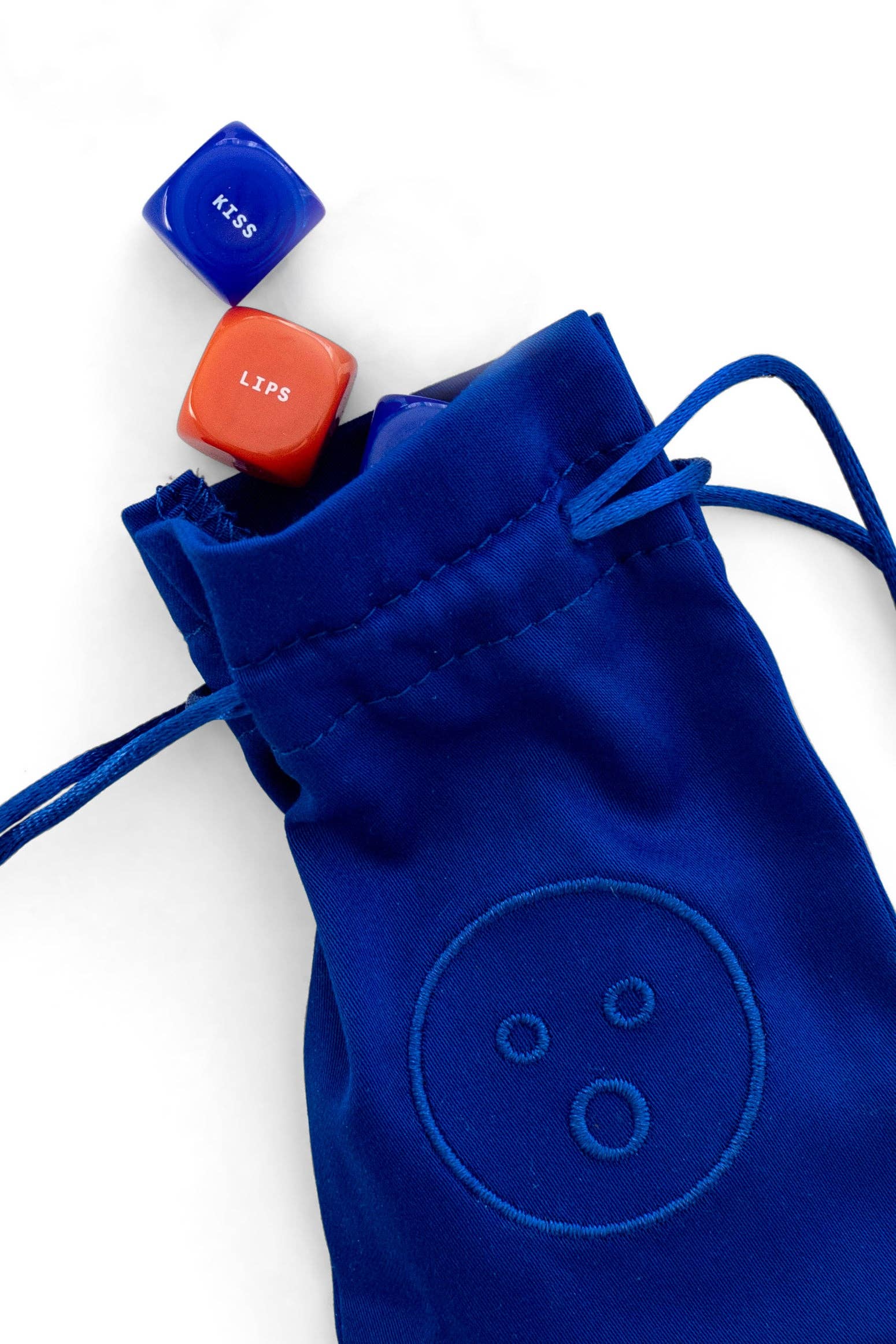 Blue drawstring bag with embroidered design on a white background