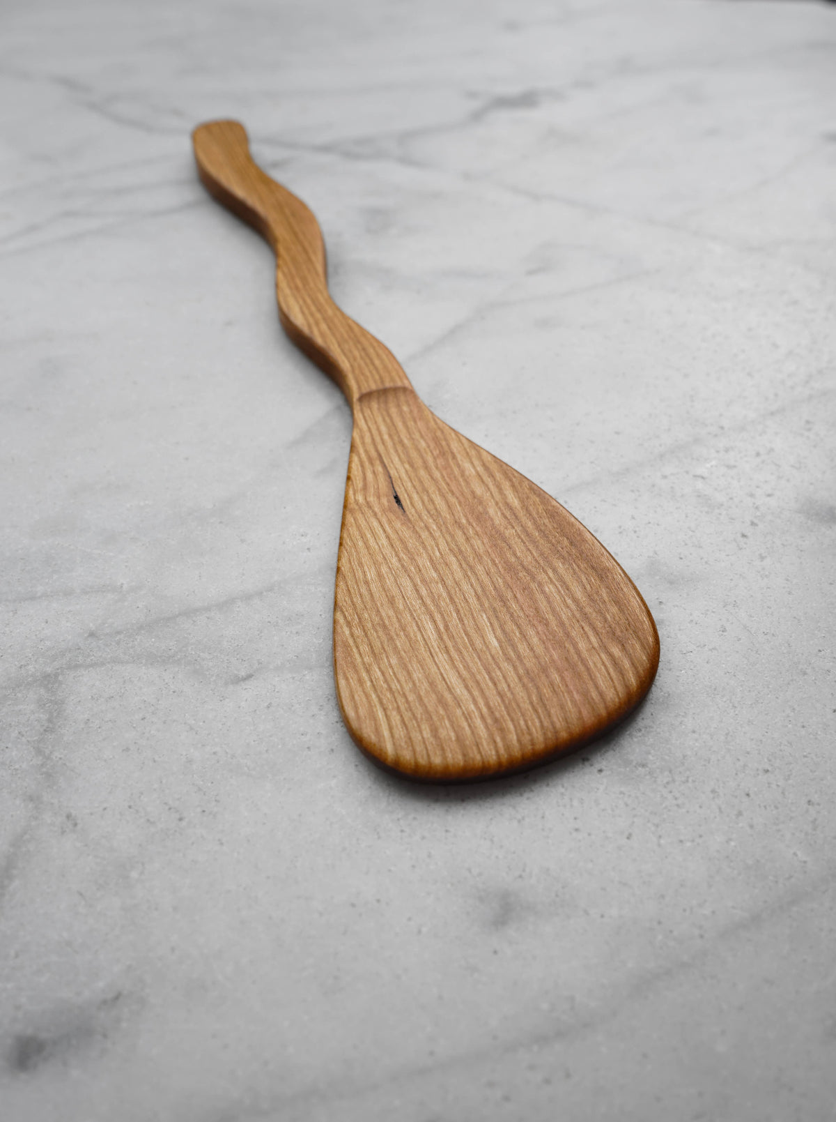 Wooden spatula on a gray marble surface