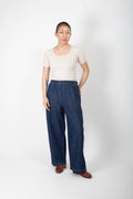 Person wearing a white top and blue jeans on a white background
