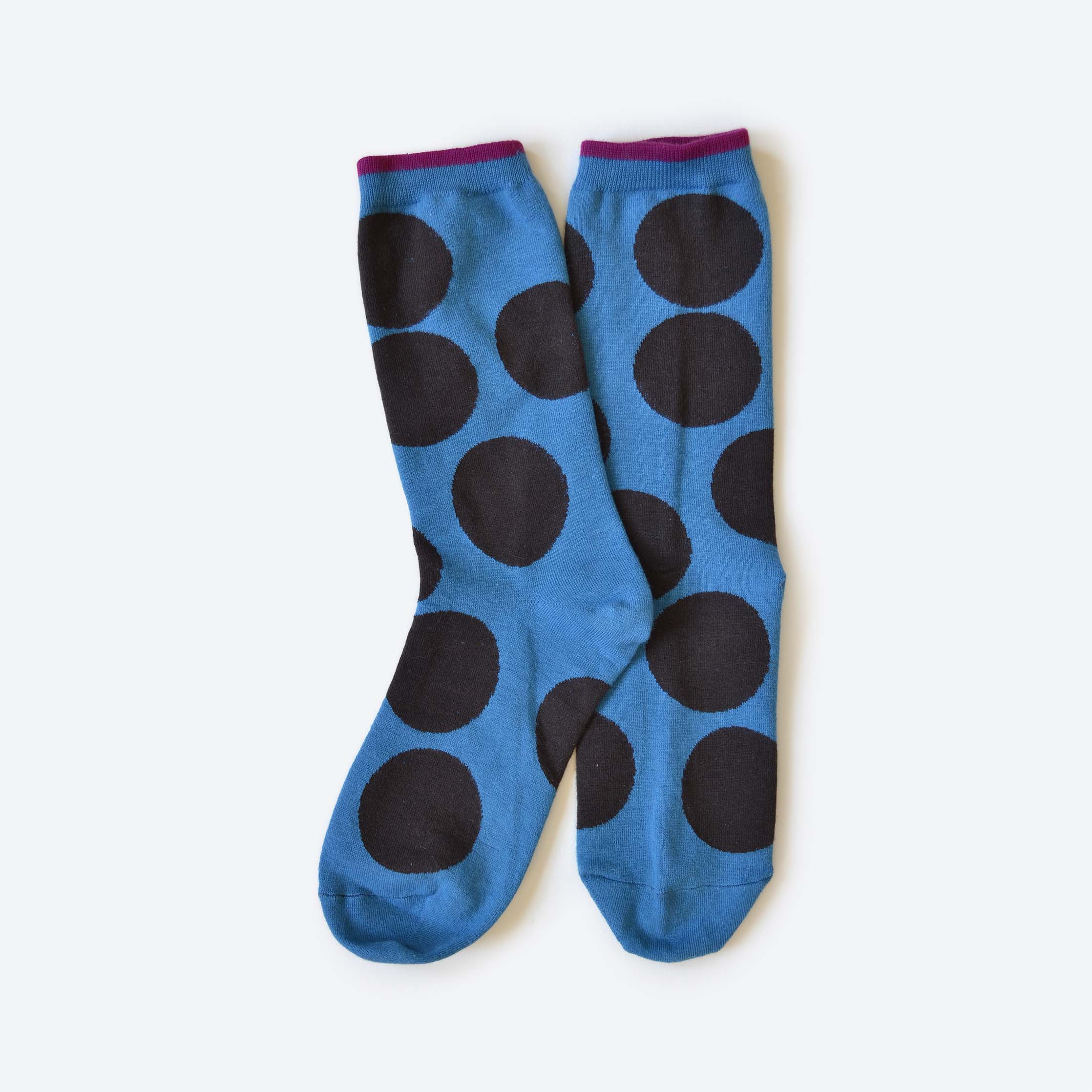 Blue socks with black polka dots on a white background