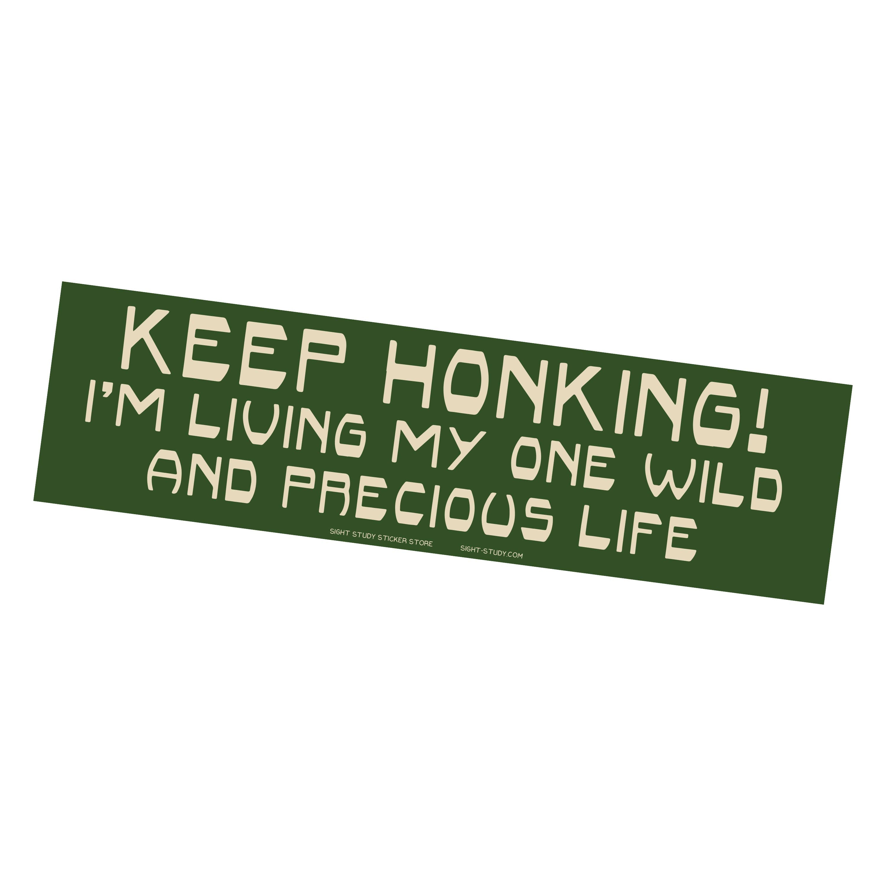 Green bumper sticker with white text on a white background