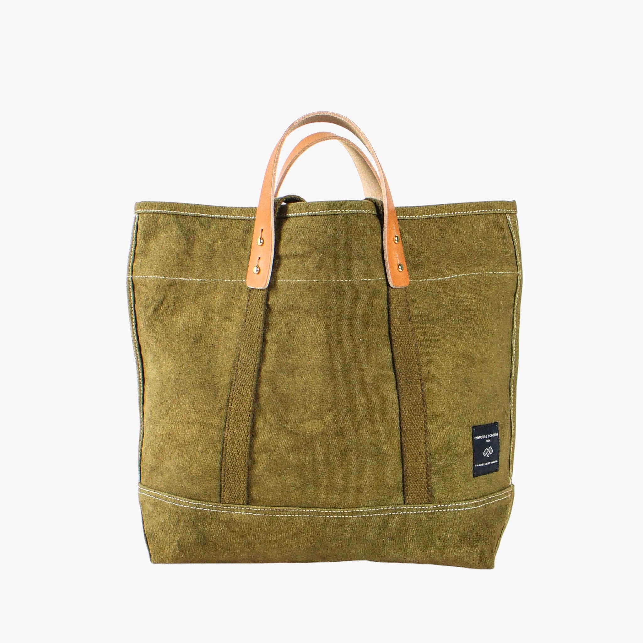 Green tote bag with leather handle on a white background