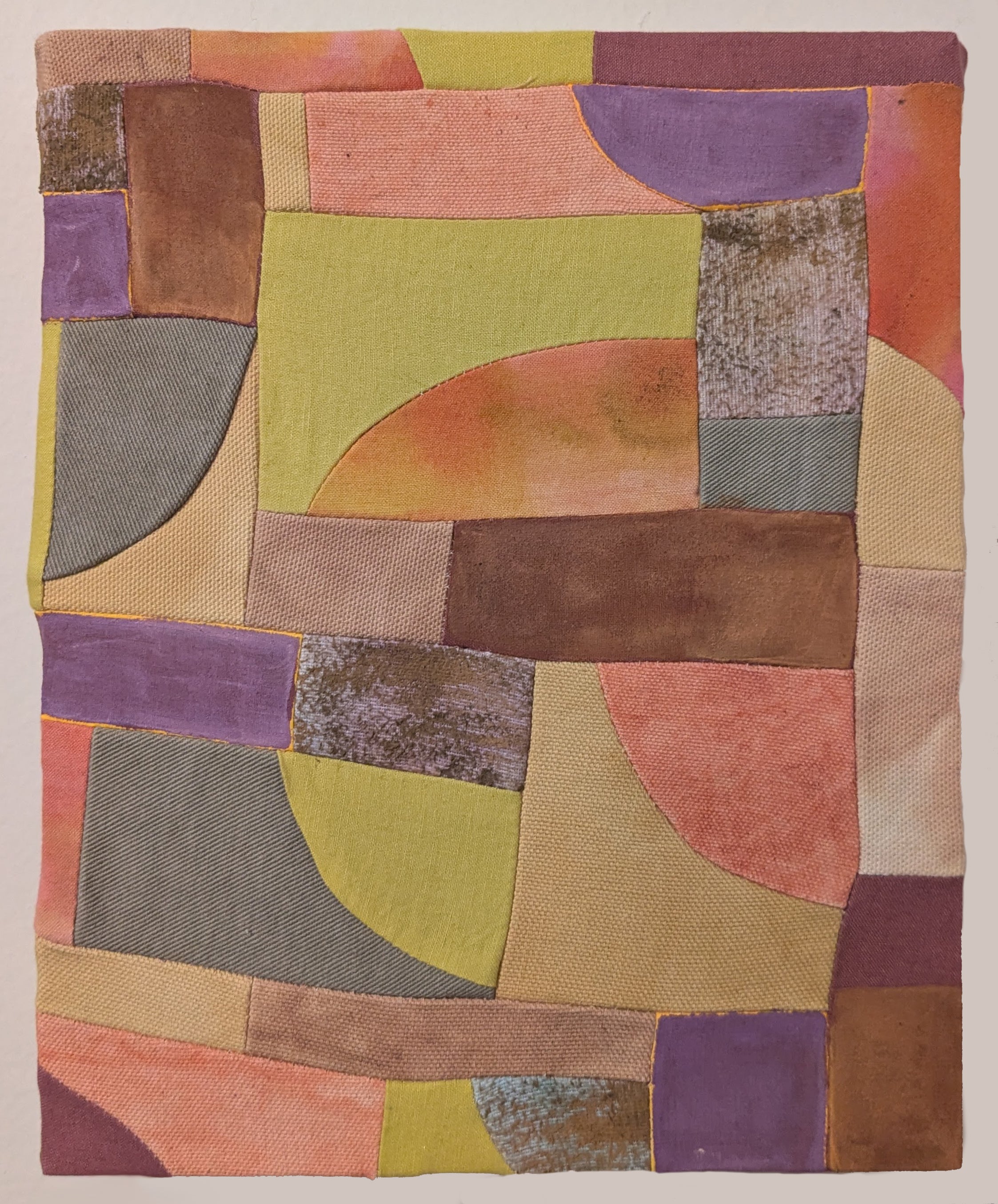 Multicolored patchwork textile with geometric patterns on a beige background