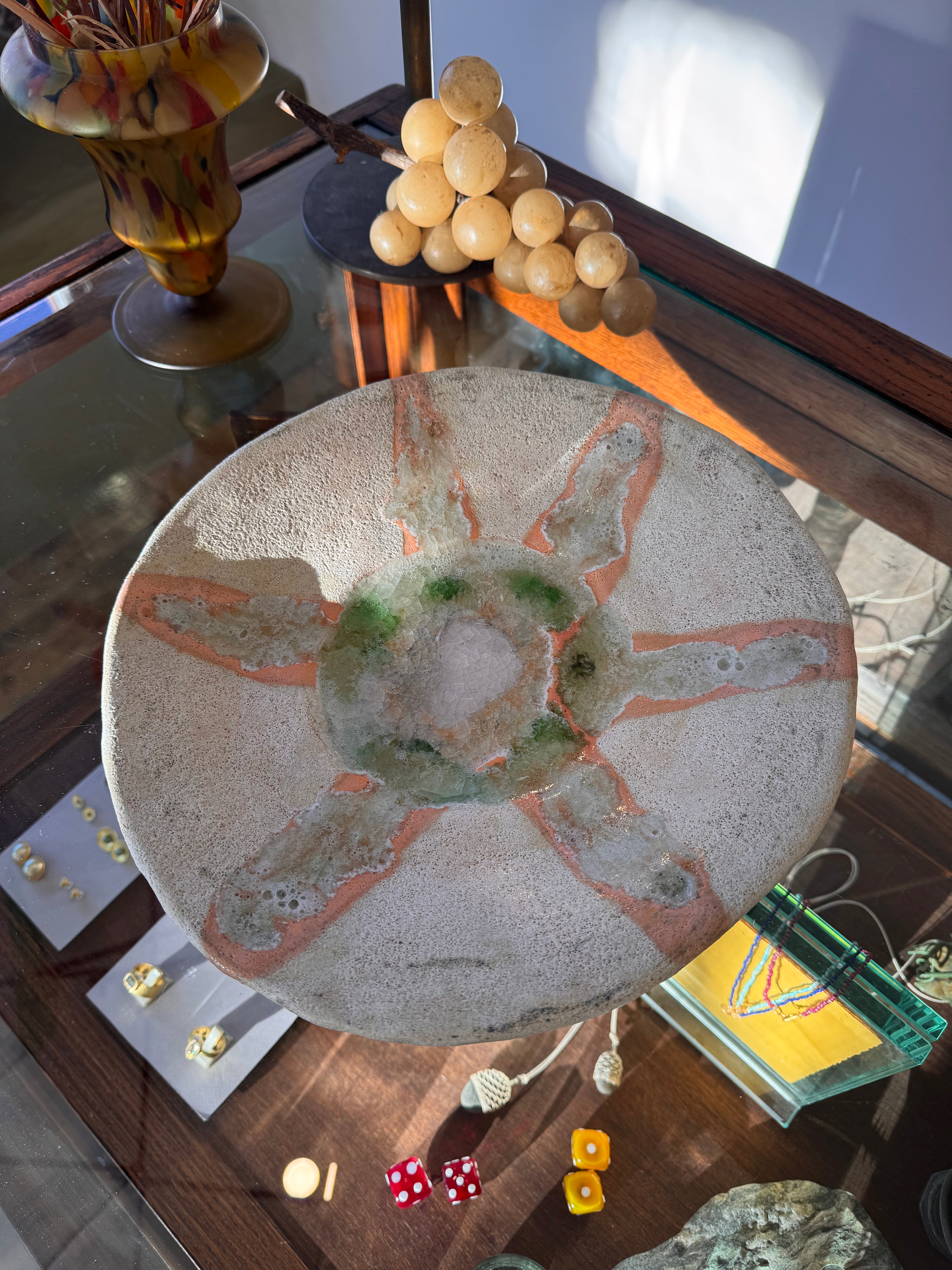 Decorative stone with artistic design on a reflective surface