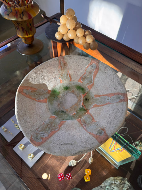 Decorative stone with artistic design on a reflective surface