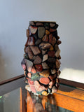 Decorative item made of stacked stones against a neutral background