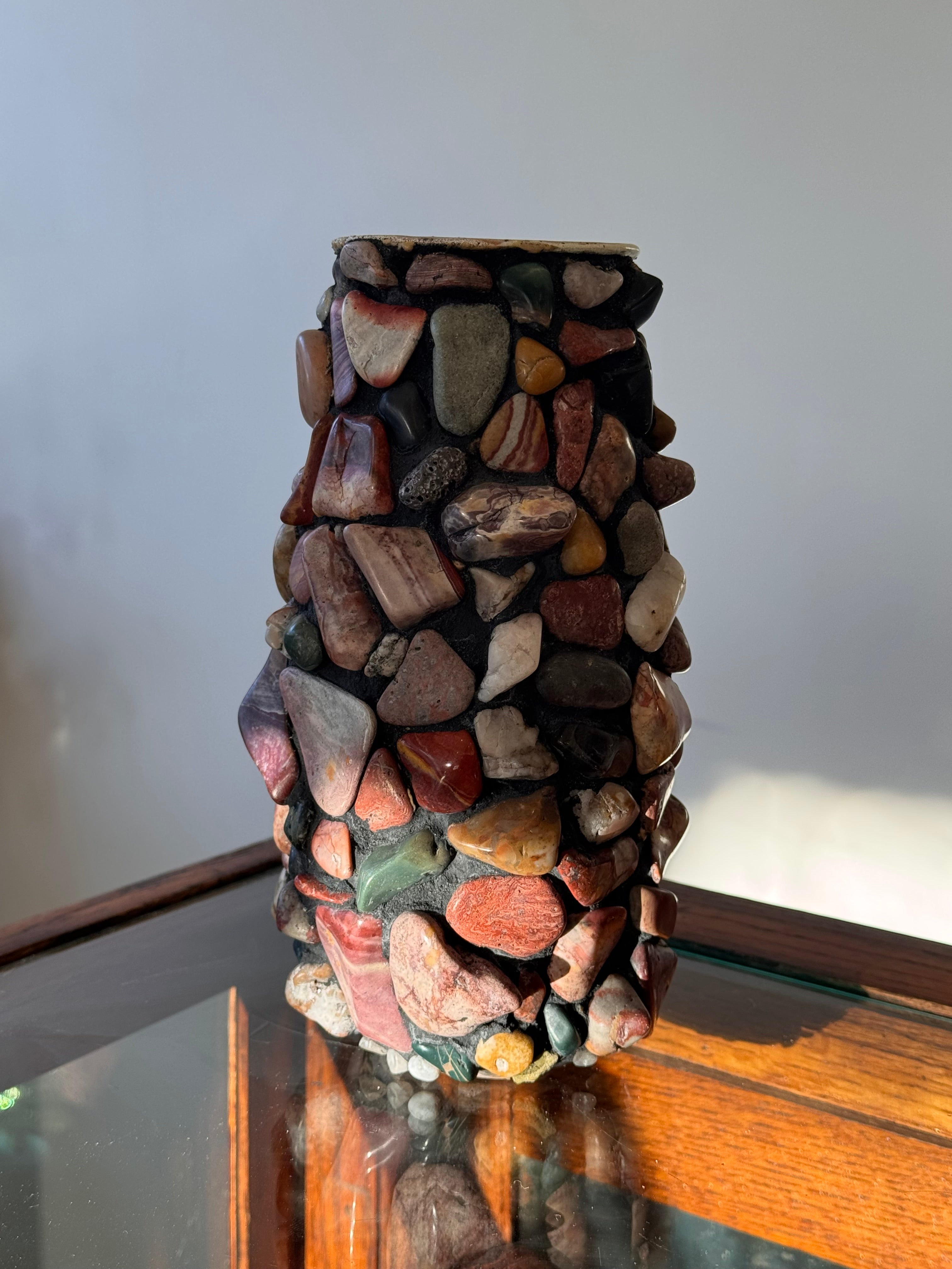Decorative item made of stacked stones against a neutral background