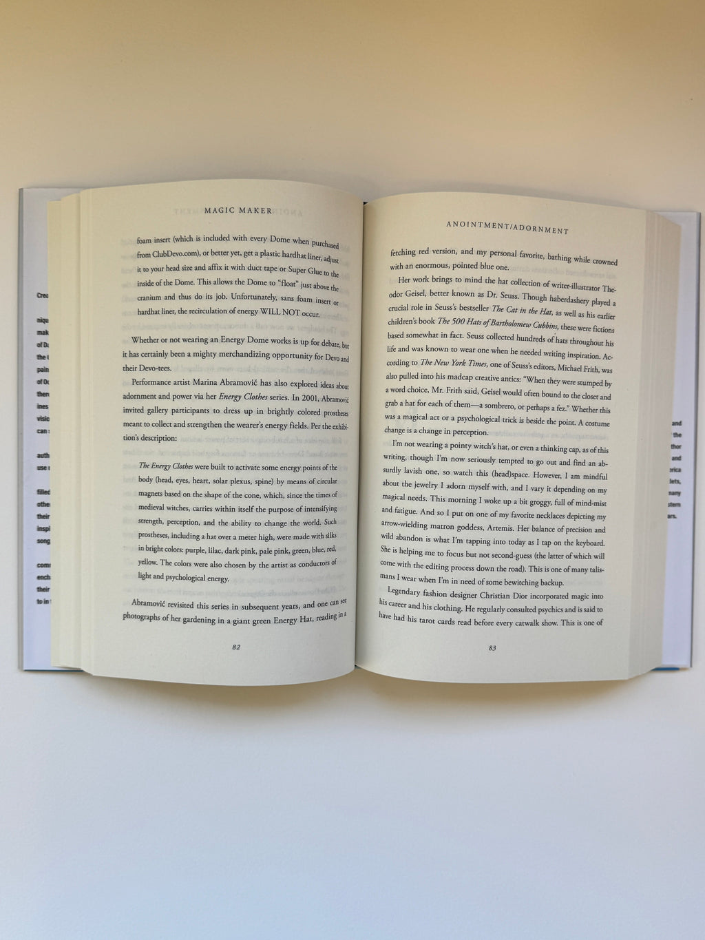 An open book with cream-colored pages and dense black text, photographed from above against a plain light background.