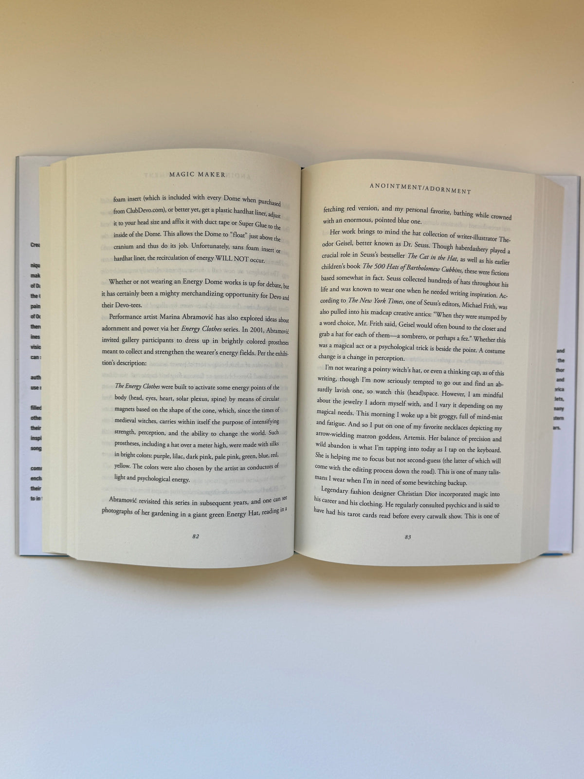 An open book with cream-colored pages and dense black text, photographed from above against a plain light background.
