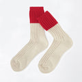 A pair of ribbed ankle socks with a solid red cuff and a cream-colored body, displayed on a clean white background.