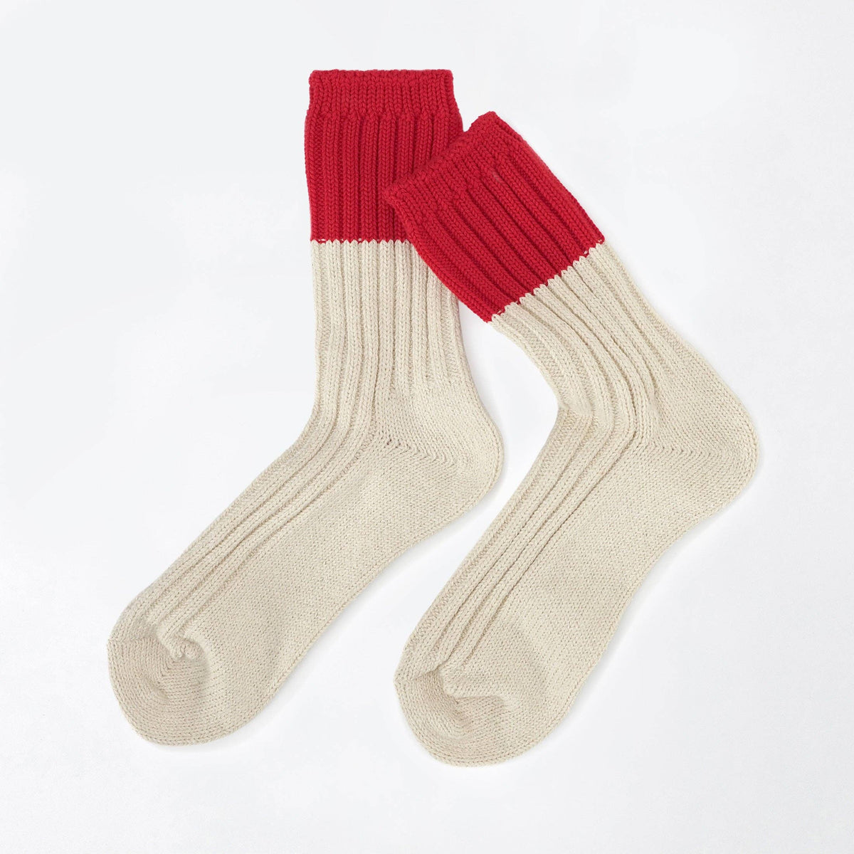 A pair of ribbed ankle socks with a solid red cuff and a cream-colored body, displayed on a clean white background.