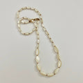 Necklace with shell beads on a light gray background