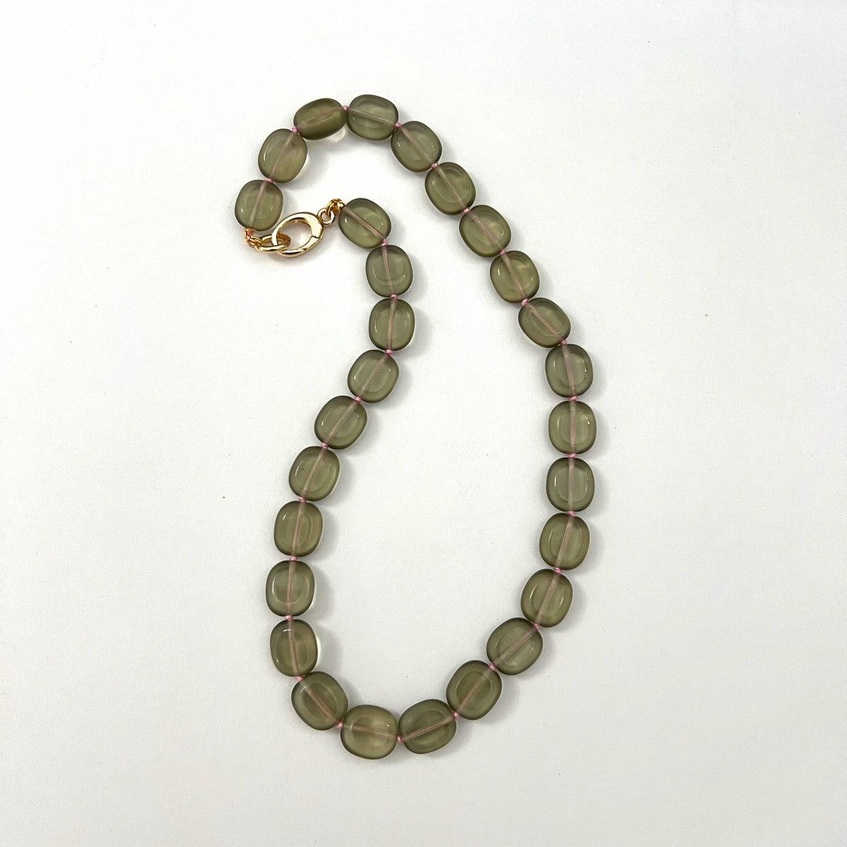 Gray beaded necklace on white background