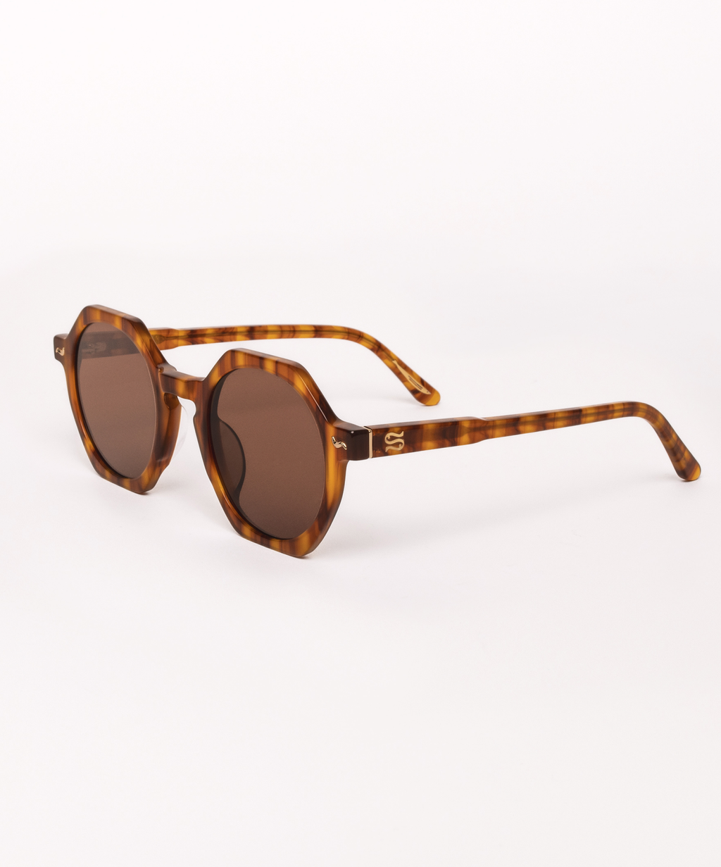 Tortoiseshell sunglasses with brown lenses on a white background