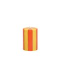 Striped red and yellow candle on a white background