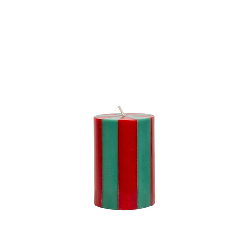 Striped red and green candle on a white background