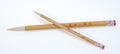 Two wooden brushes with red text on a white background