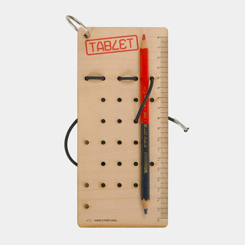 Wooden pegboard with holes, a red pencil, and a ruler on a white background
