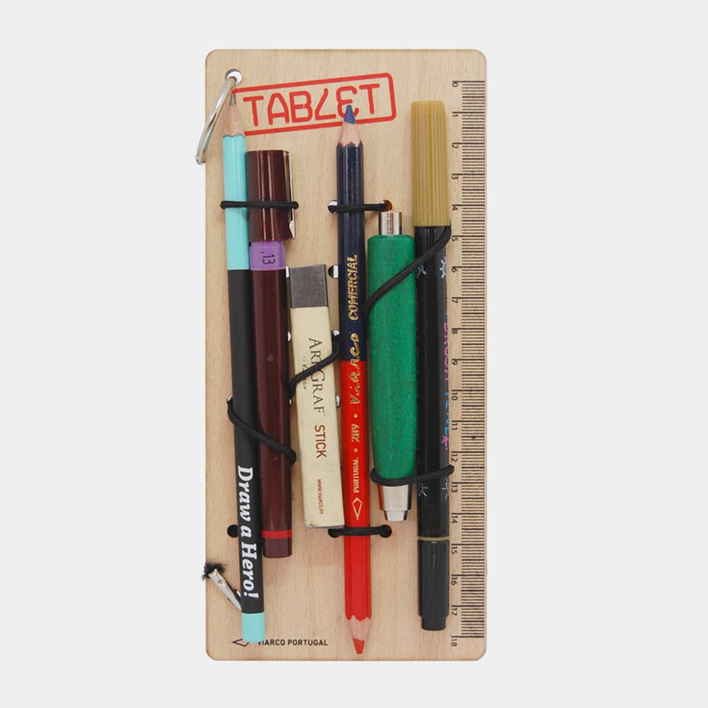 Set of pens and pencils on a wooden peg board holder with ruler, featuring 'Drawer Hero' and 'Marco Portuga'.