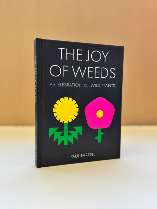 The Joy of Weeds: A Celebration of Wild Plants book by Paul Farrell, featuring a black cover with colorful illustrations of a yellow daisy and a pink flower, set against a warm beige background.