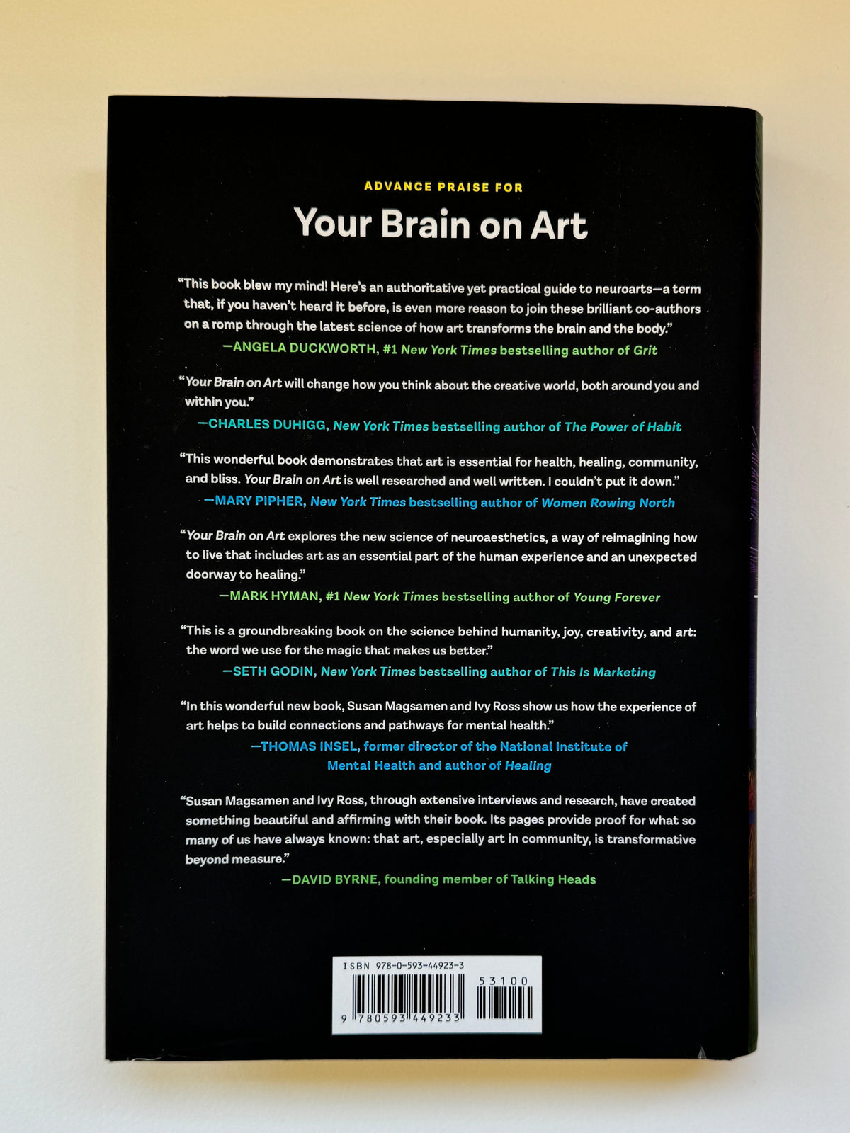 The back cover of the book 'Your Brain on Art' by James Walker, featuring a solid black background with white and yellow text and a barcode on the left, photographed flat on a light beige surface.
